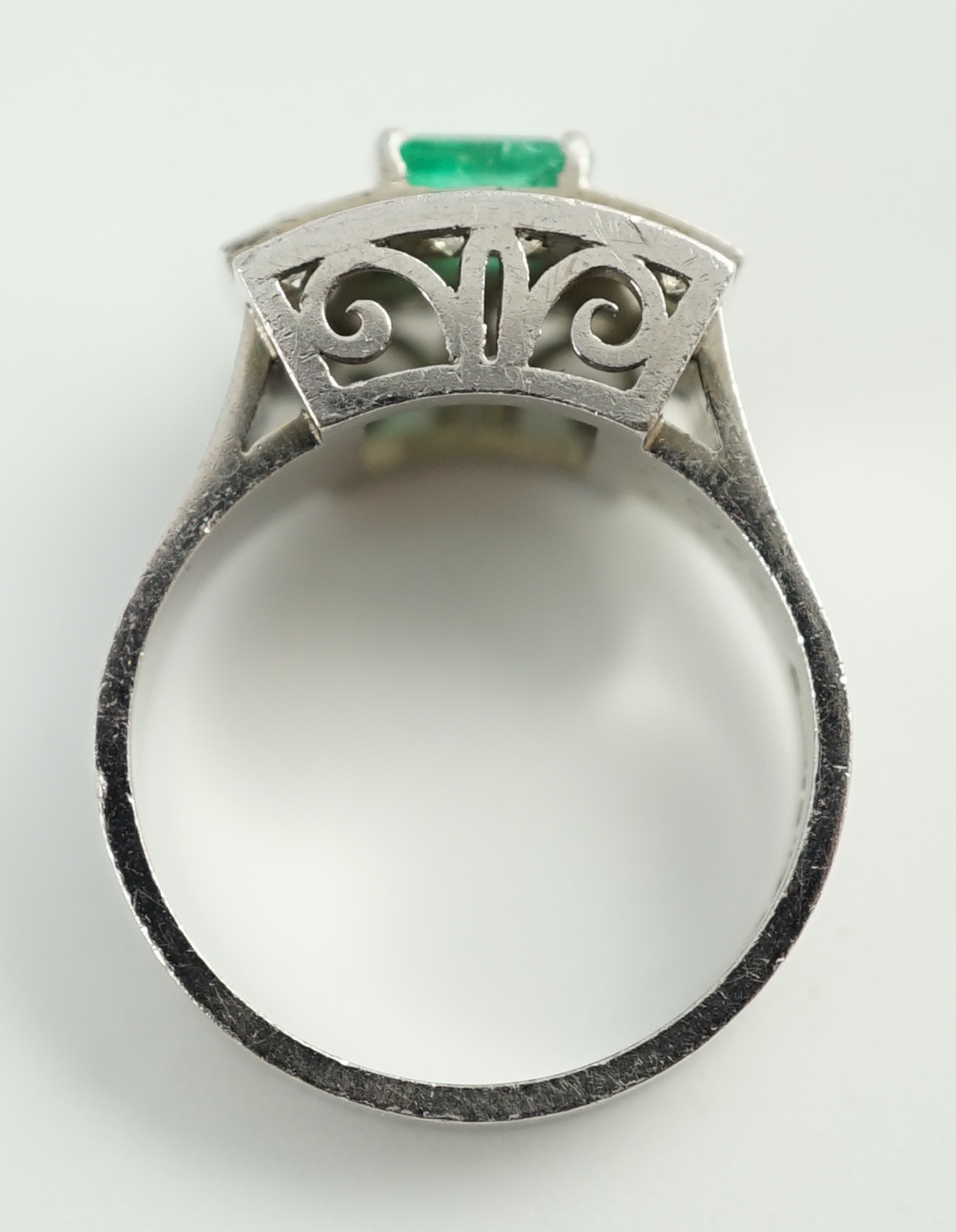 A Swedish 18k gold, single stone emerald and fourteen stone diamond set three row cluster ring